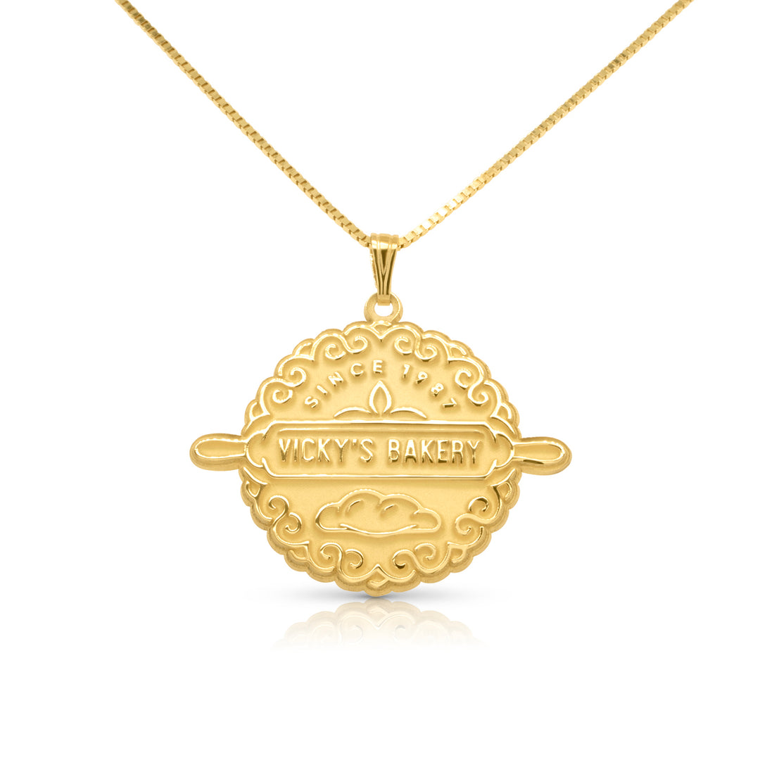 Yellow gold necklace with round custom pendant on a white background