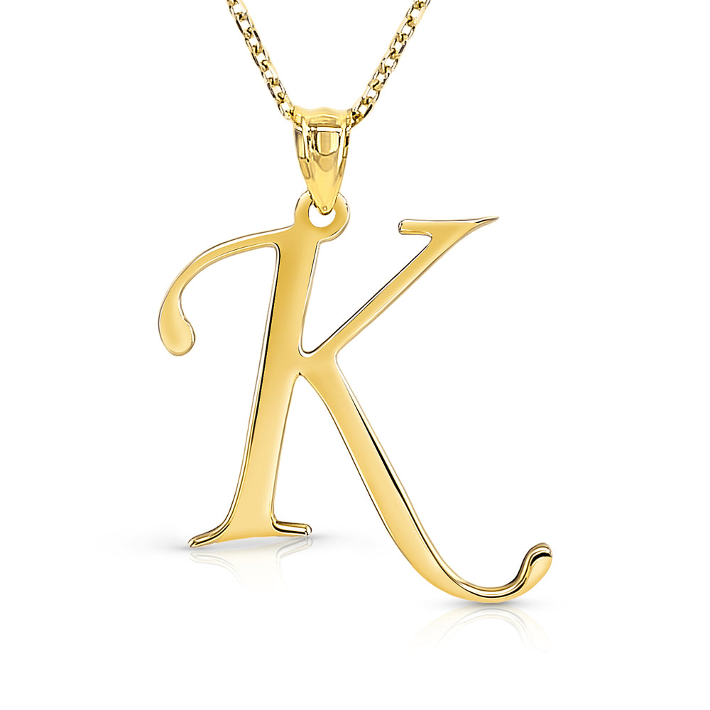 Yellow gold chain with initial K pendant on a white background