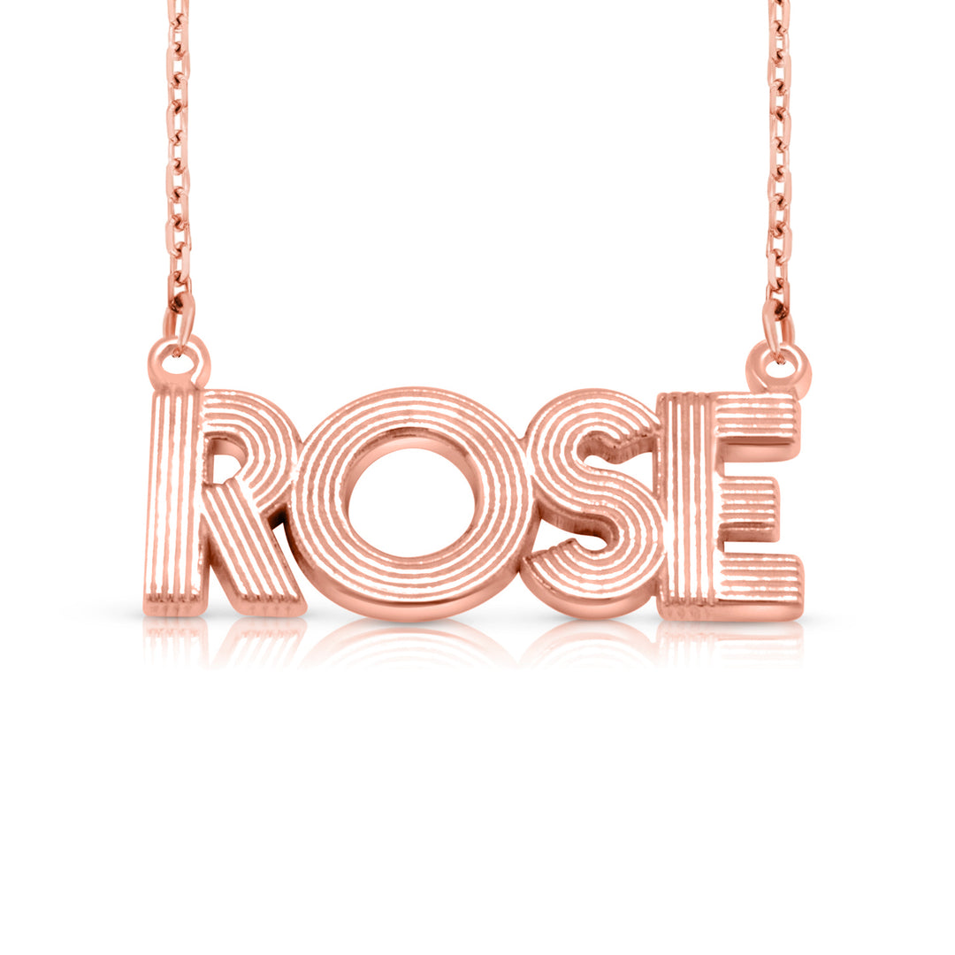 A sample of the nameplate with the name Rose in Rose Gold