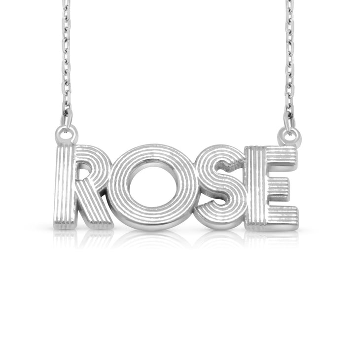 A sample of the nameplate with the name Rose in White Gold