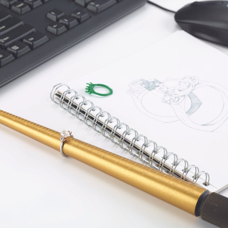 An image showing a custom jewelry design sketch and finished product with tools